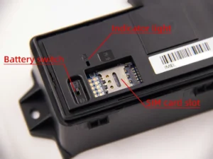 A close-up of the GAT12 tracker's interior, showing the battery switch, SIM card slot, and indicator light.