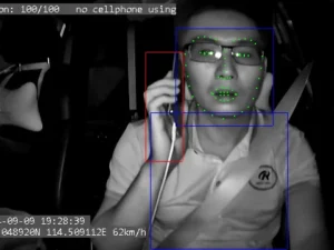 The GD14's DMS interior camera using AI facial analysis to detect a driver using a cellphone and provide a real-time alert.